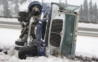 truck on its side - West Vail Shell - Eagle County Colorado Towing Company
